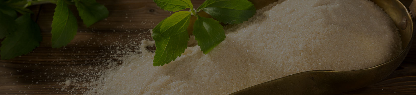 A Sugar-filled Spoon on a Wooden Table
